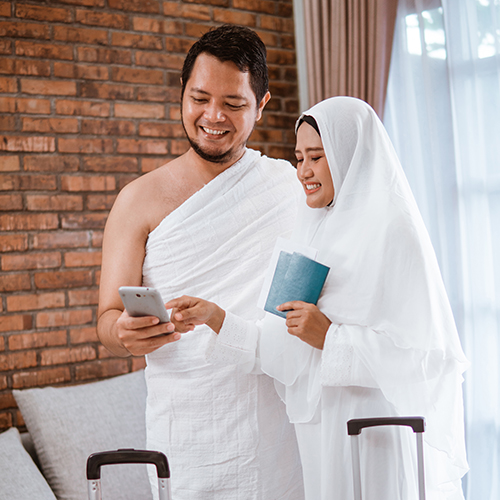 muslim couple making a phone call while umrah and hajj